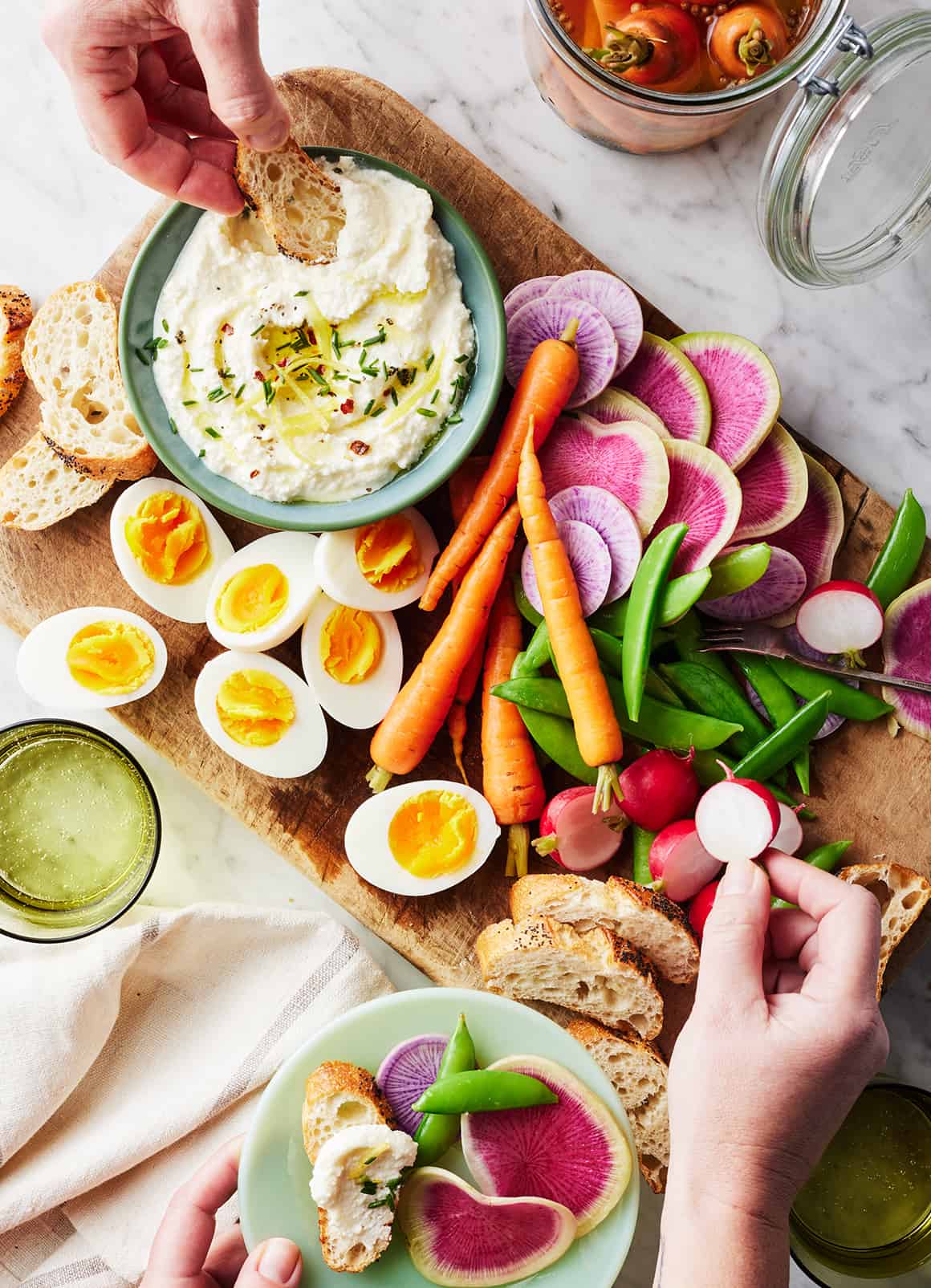 Appetizer board with whipped feta, spring veggies, and hard boiled eggs