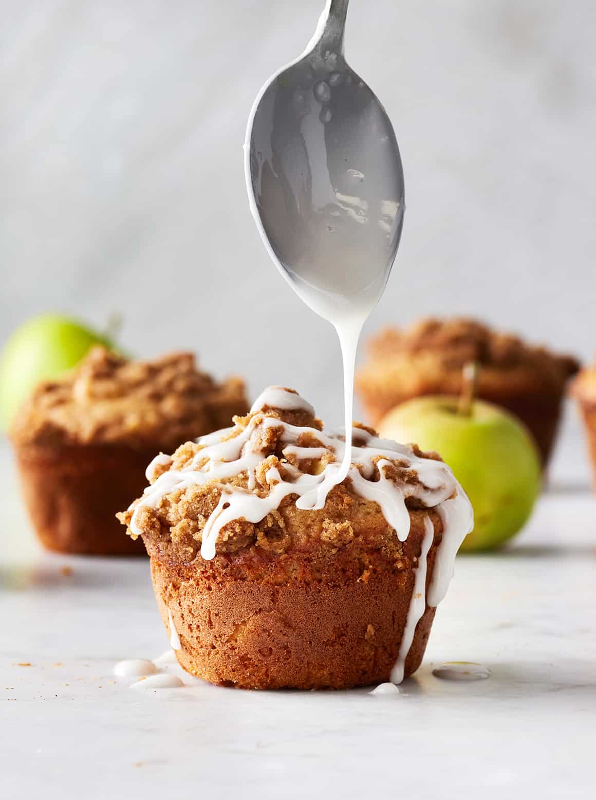 Apple muffins with cinnamon crumble topping and vanilla glaze