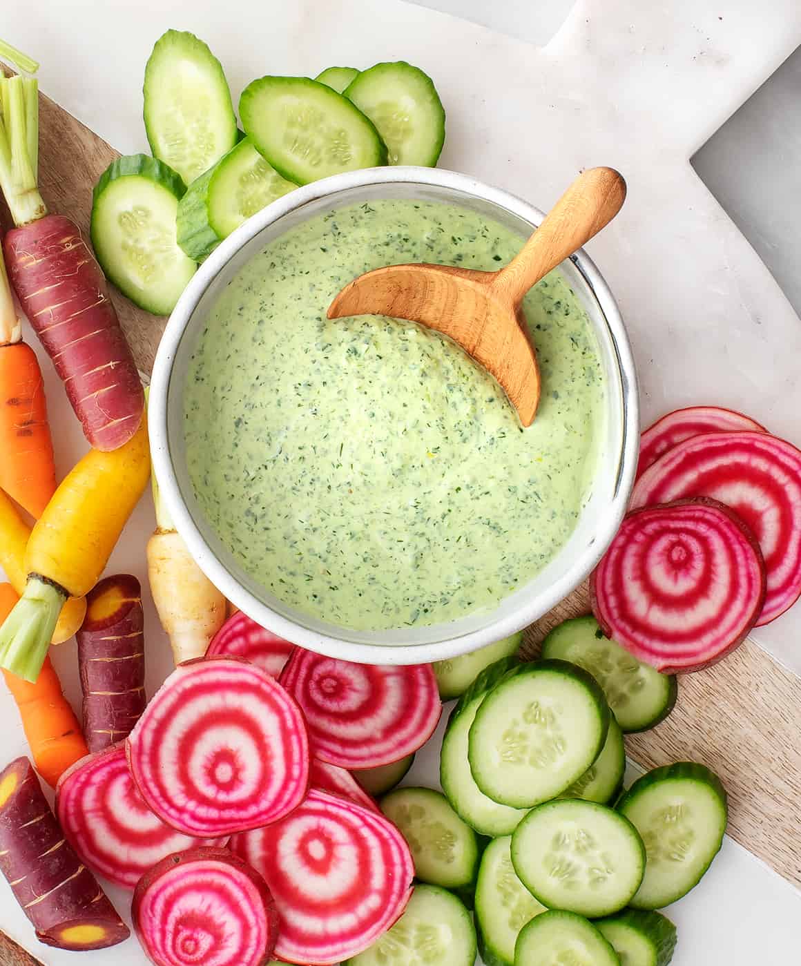 Green goddess dressing in a bowl with vegetables