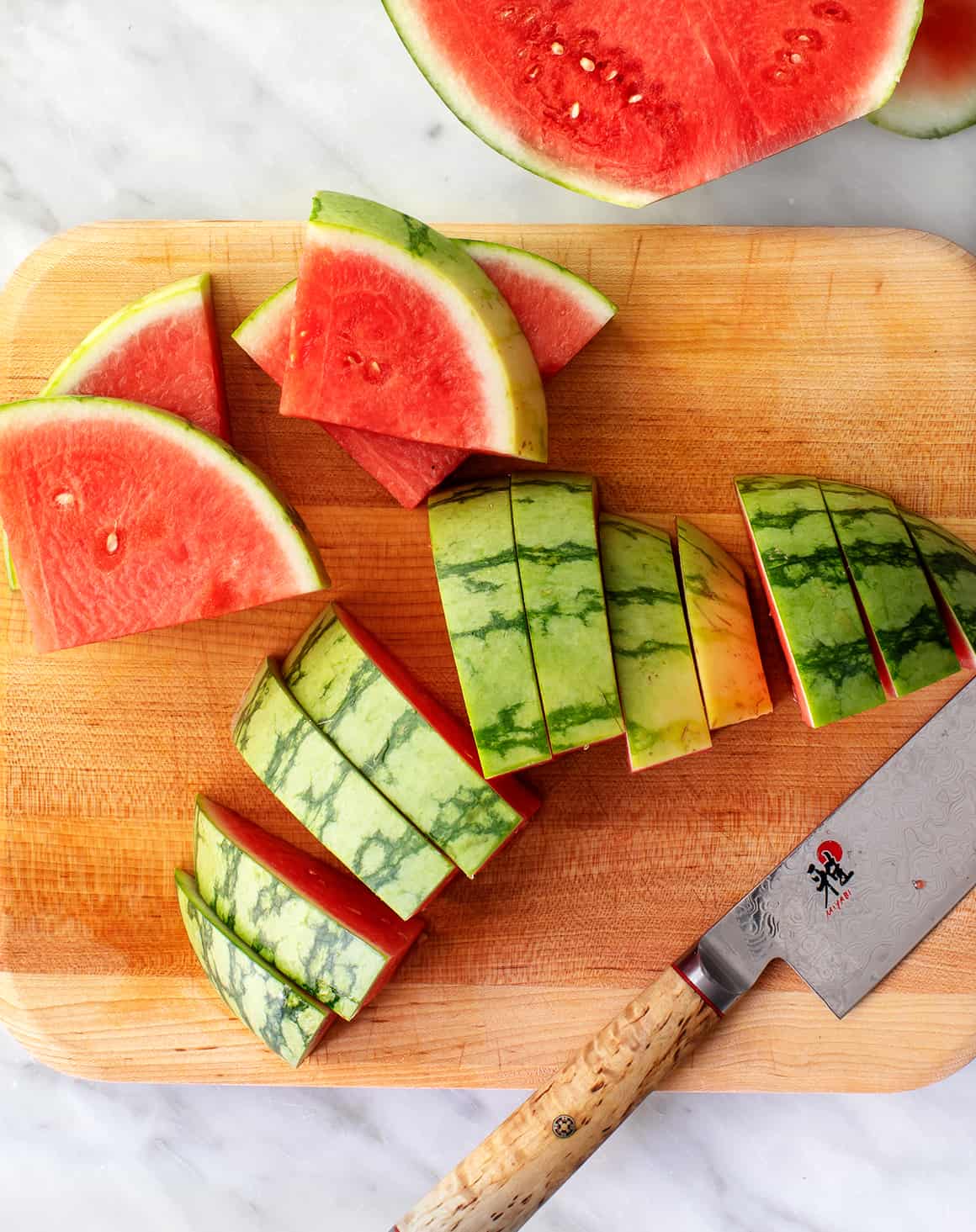 Best way to cut a watermelon - wedges on a cutting board with knife