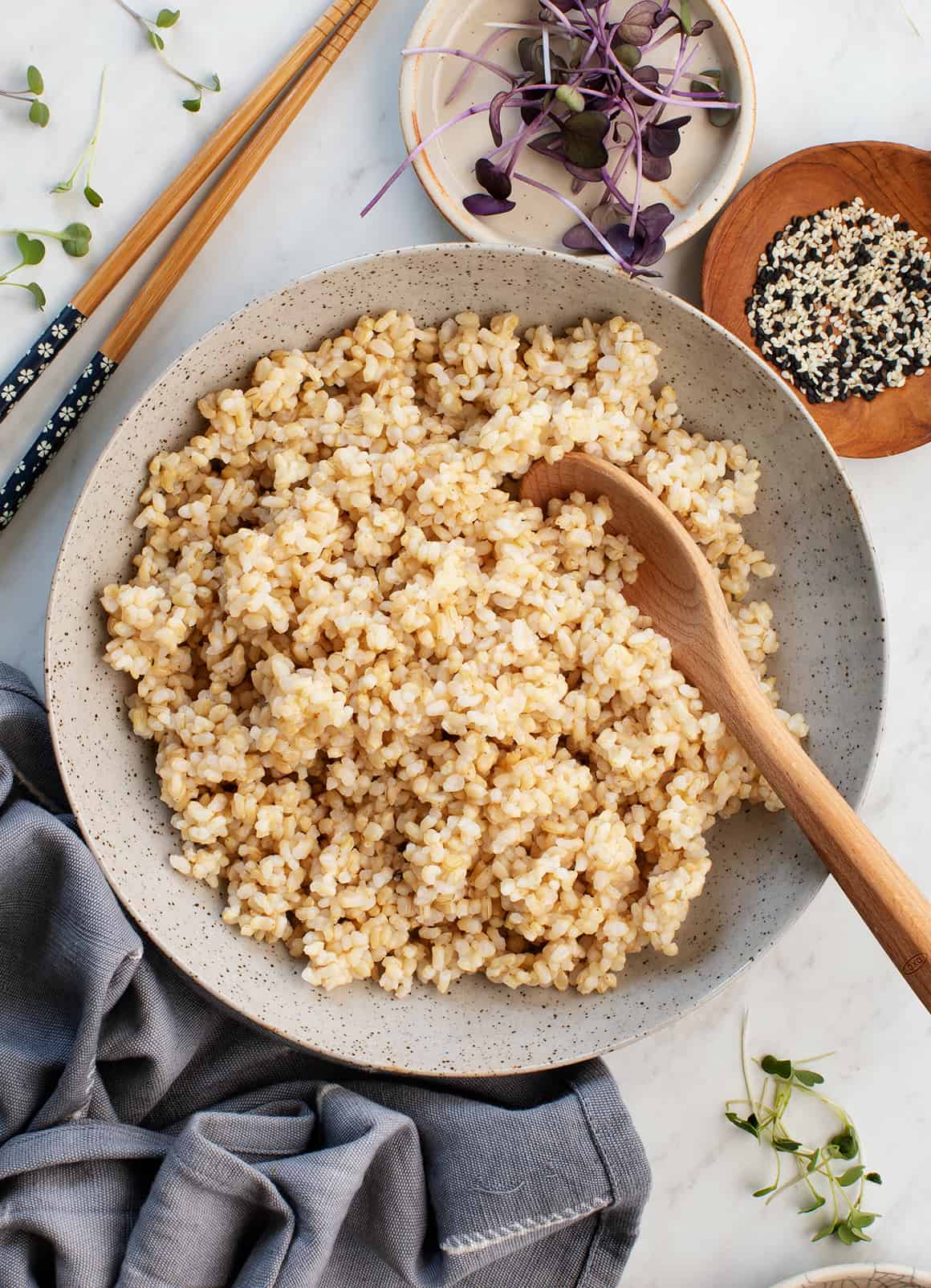 Instant pot brown rice in bowl with wooden spoon